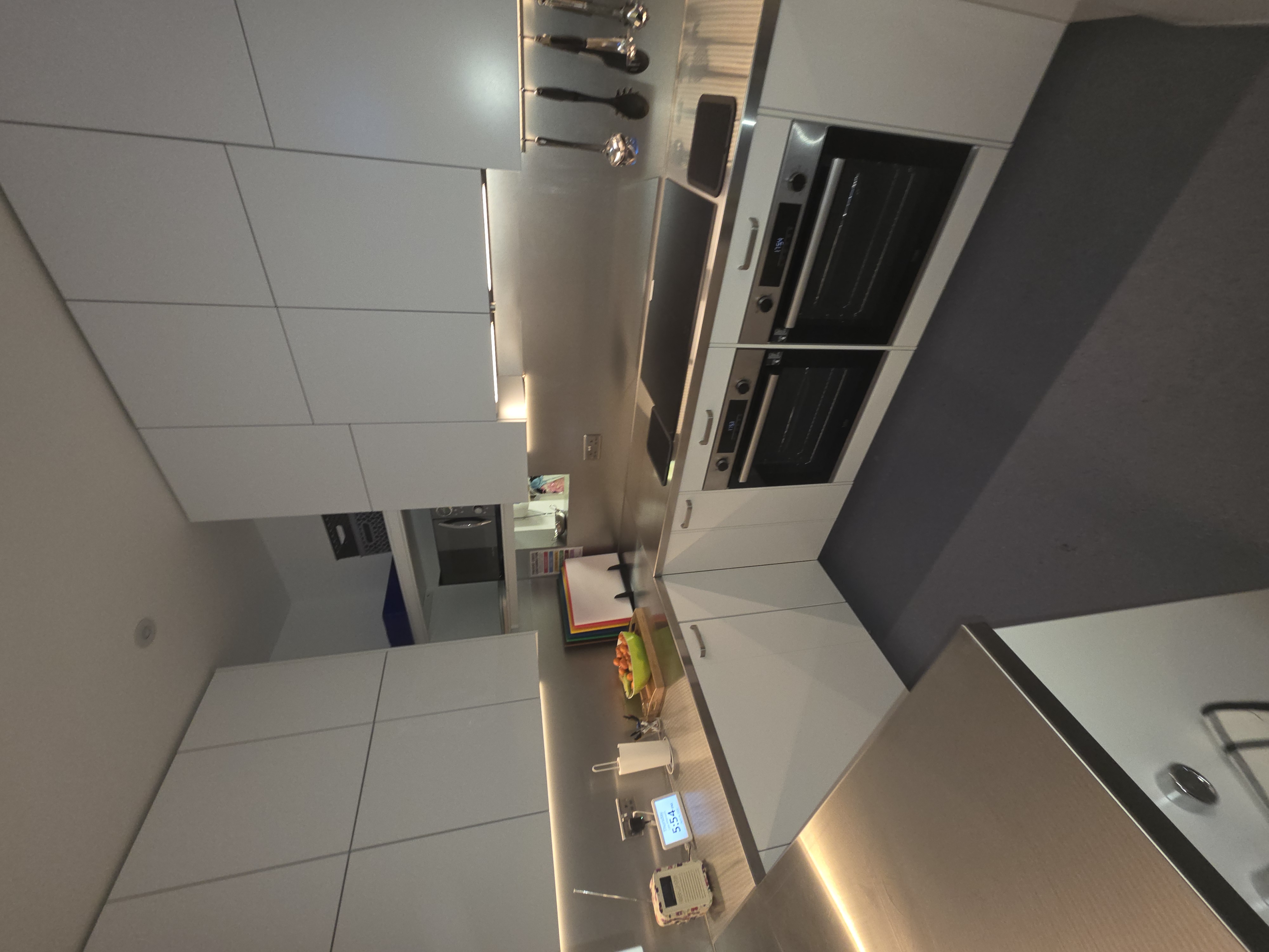 Completed kitchen with under-cabinet lighting and fitted appliances