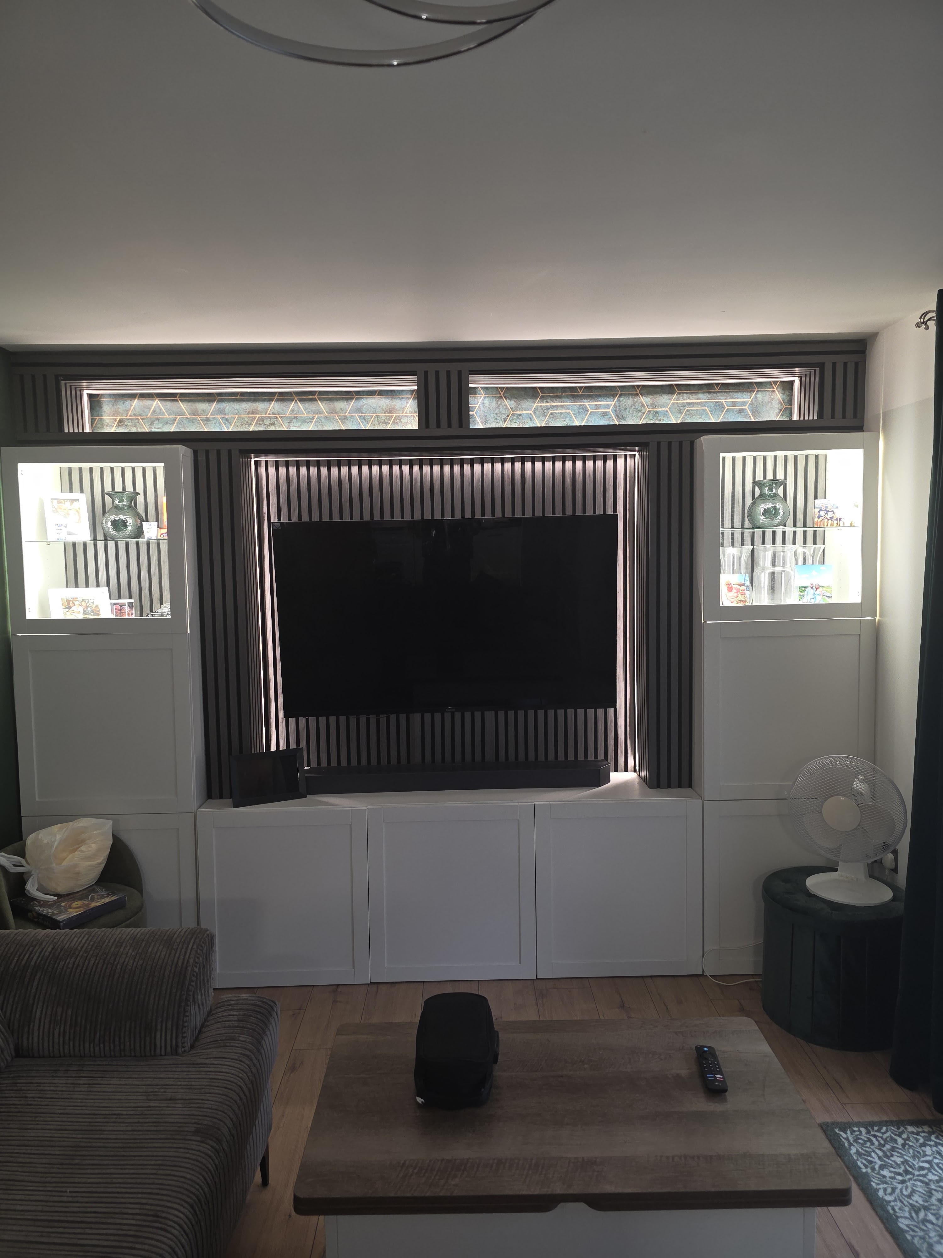 Completed slatted media wall with illuminated display cabinets